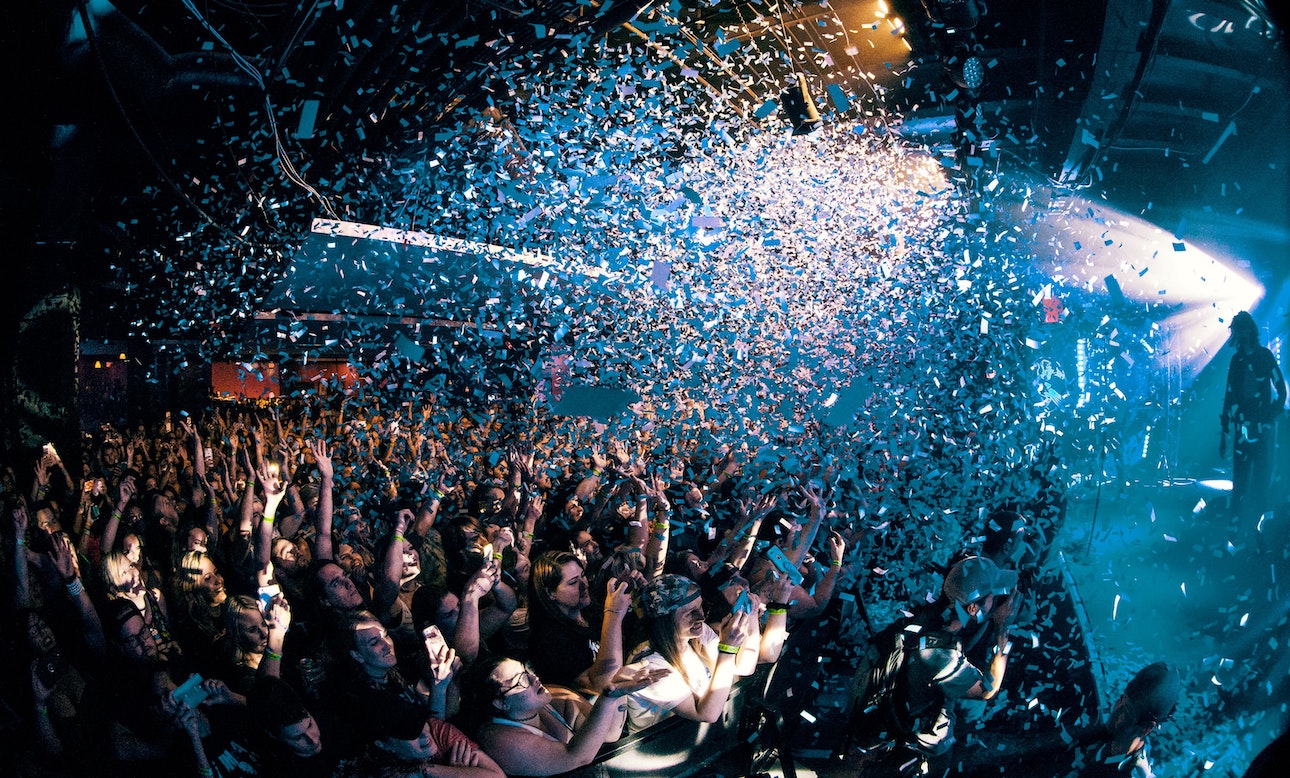 Crowd at a rock show being showered in confetti